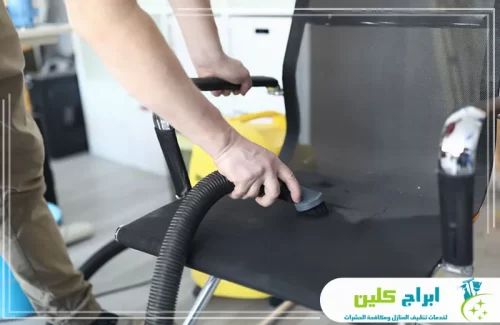 رقم شركة تنظيف مجالس بالدمام 0550234190 ابراج كلين تنظيف كرسي مكتب أسود باستخدام مكنسة شفط مخصصة للأنسجة والمفروشات.